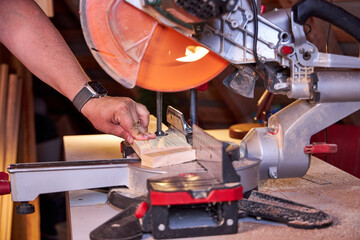 man sawing wood on a circular saw close-up