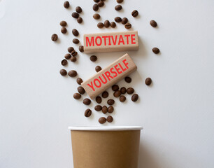 Motivation symbol. Concept word Motivate yourself on wooden blocks. Beautiful white background with coffee beans and cup. Business and Motivate yourself concept. Copy space