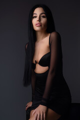 Naklejka premium Seductive sexy lovely attractive young sensual woman with perfect slim body posing on studio background. Beautiful elegant sexy model, studio portrait. Sensual beautiful woman face.
