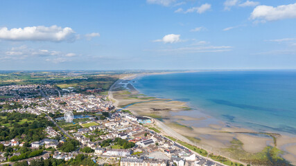 Aerial view on houses on coast of see in Newcastle, Northern Ireland. Coastal town, Drone photo