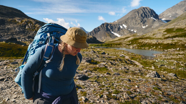 Woman putting her hiking bag on