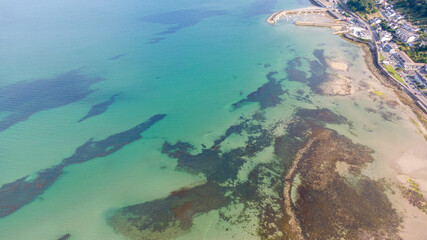 Aerial view on houses on coast of see in Newcastle, Northern Ireland. Coastal town, Drone photo