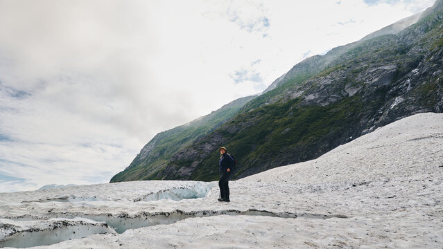 Hiker on icy glacier 