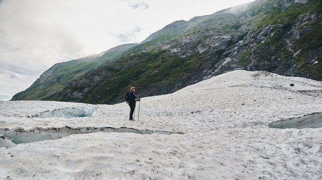 Hiker on icy glacier 