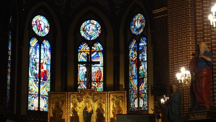 Obraz premium The interiors of a cathoric church in Szczecin (Roman Catholic Parish of St. John the Baptist) with stained glass window