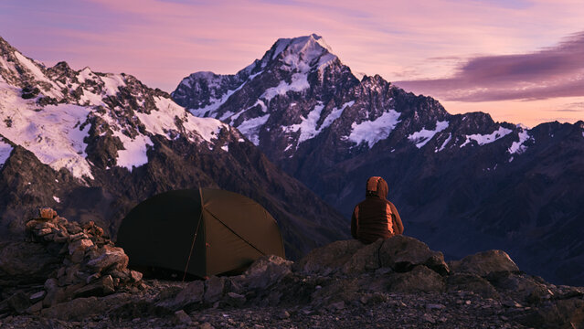 Snow-Capped Peaks at Dusk Hiker watching sunrise

