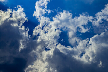 Thunderstorm cumulus clouds on blue sky. Cloudy weather. White cumulus clouds. Skies before thunderstorm. Background image. Beauty of nature. Outer space.