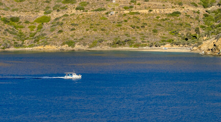 Small fishing boat, trawler on rippled sea water background, Greece