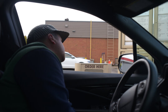 Car drive through man ordering food 