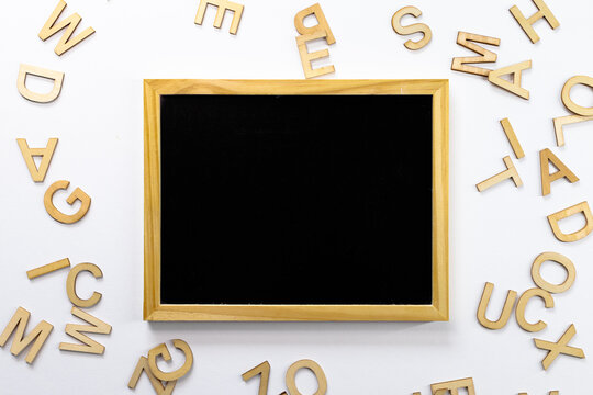Black school board. Near scattered letters. View from above. For backgrounds and presentations - Powered by Adobe