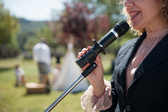 Woman speaking into microphone during wedding