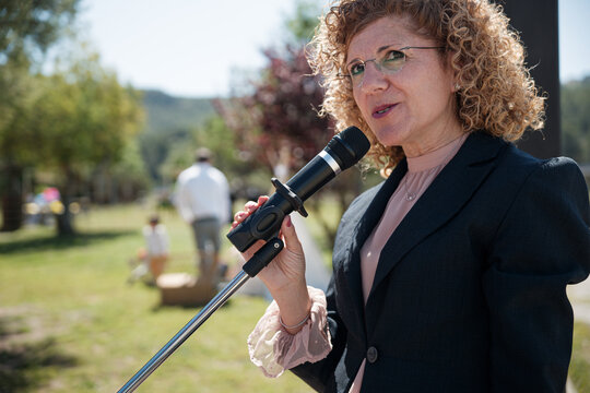 Woman speaking into microphone 