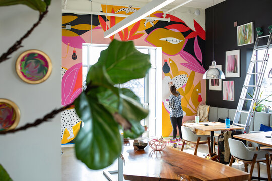 Artist Painting Mural in Workspace