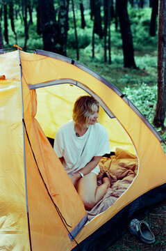 Calm female in tent during camping