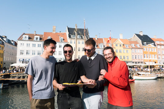 friends visiting copenhagen and looking at a map very happy 