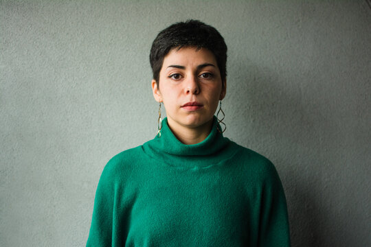 Latina woman neutral expression portrait.