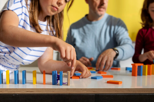 Kid Experimenting With Dominos