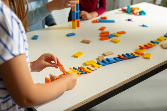 Kid Experimenting With Dominos
