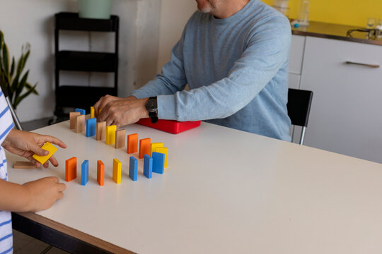Kid Experimenting With Dominos