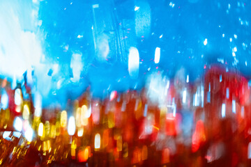 A bright abstraction of shiny bokeh behind glass and text space