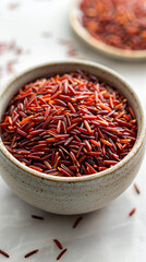 Fototapeta premium Vertical macro closeup cover background banner photo of of raw Basmati red rice in ceramic bowl with blank white space 