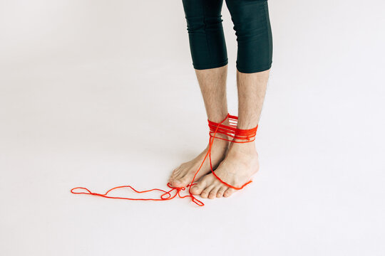 Feet tangled in the red rope 