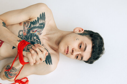 Tattooed Man With Red Rope