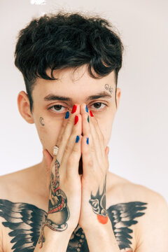Man with tattoos covering face