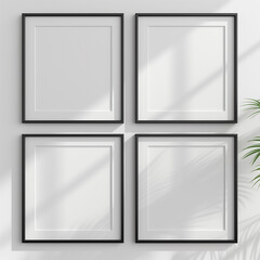 Fototapeta premium Minimalist four square black frames on a white wall with clean lines 