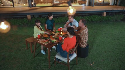 Family gather celebrate holiday. Parents, grandparents and girl together to relax and have dinner party food. Outdoor activity for spending time with multigeneration cross generation gap. Divergence.