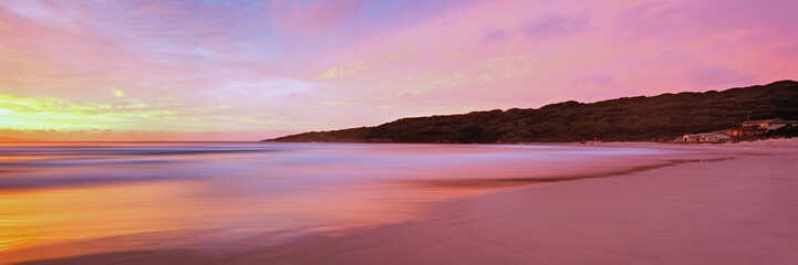 Long exposure soft pastel sunrise over beach