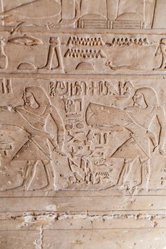 Ancient Egyptian hieroglyphics on stone wall, cultural heritage