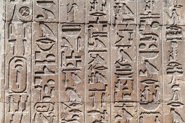 Ancient Egyptian hieroglyphics on stone wall, cultural heritage