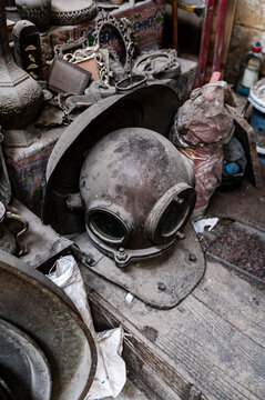Antique diving helmet in cluttered market stall