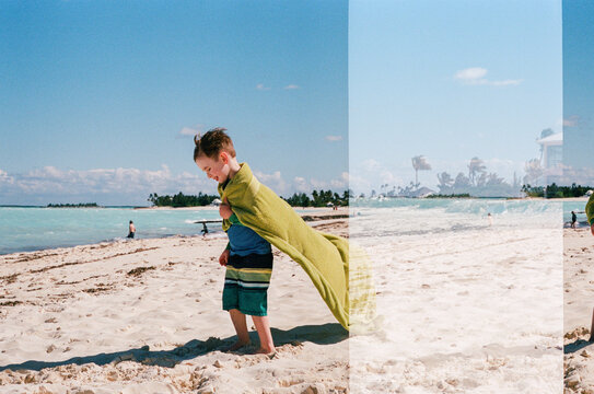 Boy on beach w towel, accidental Double exposure vacation film photo