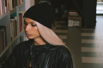 woman searching for a book in a bookstore