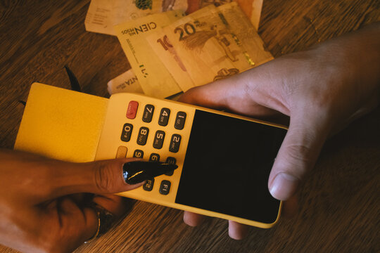 woman paying with card at bar