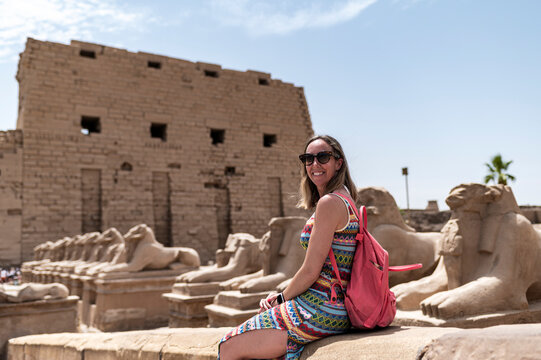 Woman tourist with backpack  at Karnak Temple, Travelling Egypt