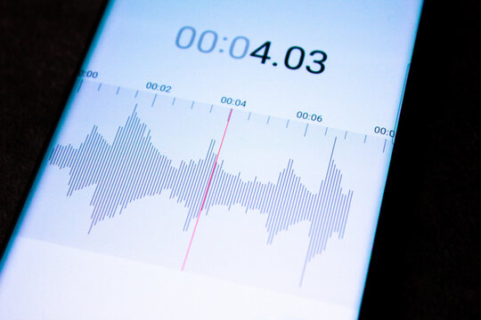 Voice recorder on a smartphone. Voice recording wave on the screen of a smartphone. Recording sounds on a smartphone. Voice recorder noise level wave.
