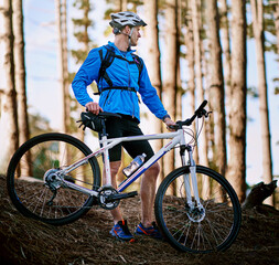 Obraz premium Cyclist, cycling and mountain biking in nature with break, dirt and trees for fitness, adventure and health. Man, bicycle and exercise outdoor in forest for workout, sports and training with courage