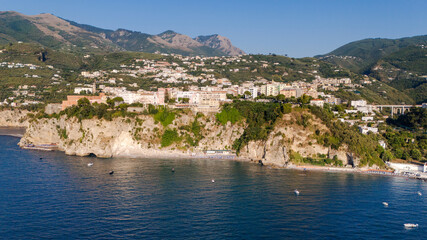 Obraz premium Vico Equense's city built on a cliff overlooking the sea on the Sorrento Coast. Aerial view. Naples, Italy. Vesuvius