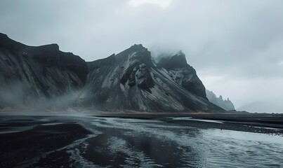 Fototapeta premium Mountains, water and black sand in Iceland