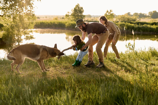 family have a fun with a dog in nature