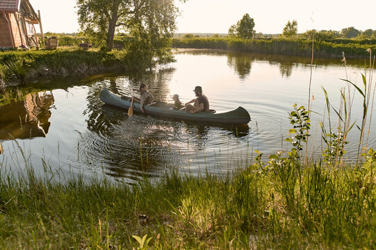 joyful family canoeing on a river