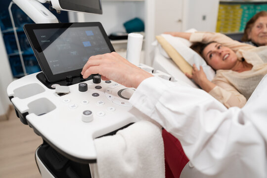 Medical professional operating ultrasound equipment