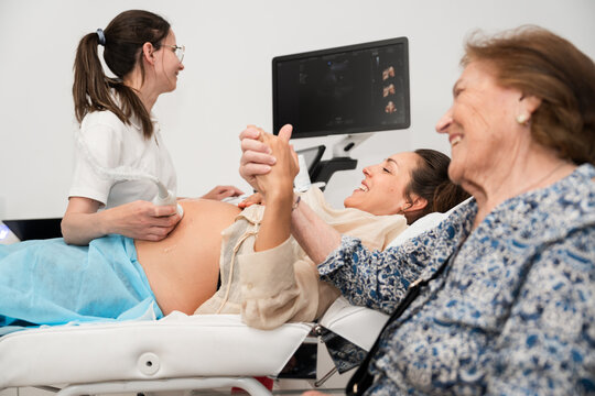 Joyful family at prenatal ultrasound appointment