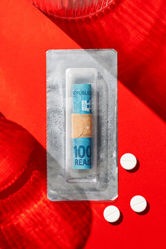 Brazilian real banknote roll  in medicine blister pack with pills 
