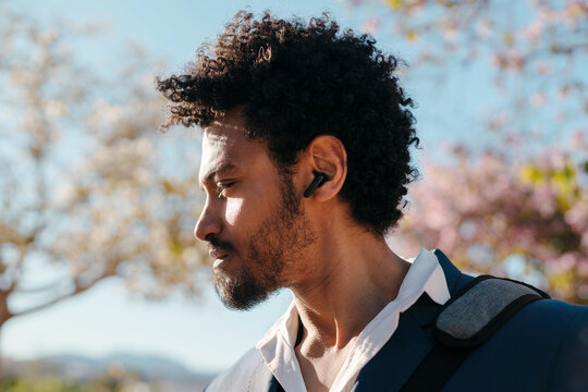 Man with bluetooth audio earbuds