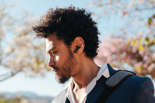 Man with bluetooth audio earbuds