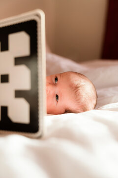Newborn baby looking at black and white flashcards
